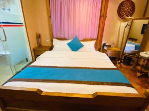 Ένα ή περισσότερα κρεβάτια σε δωμάτιο στο Juxian Boutique Homestay
