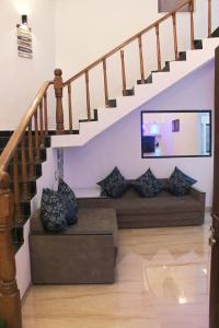 a living room with stairs with pillows at VILLA CASA SUMANJO (3BHK) in Calangute