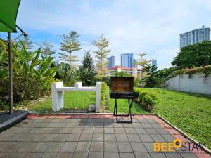 a barbecue grill in front of a cross in a park at Bangsar Three Storey Luxury Landed House 19PAX in Kuala Lumpur