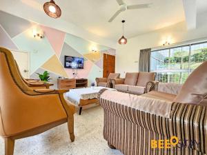 a living room with two couches and a tv at Bangsar Three Storey Luxury Landed House 19PAX in Kuala Lumpur