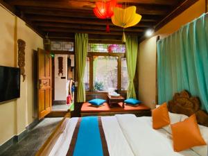 a bedroom with a bed and a living room at Juxian Boutique Homestay in Lijiang