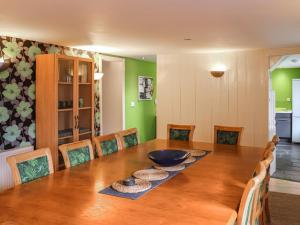 a dining room with a wooden table and chairs at Bryn Marian in Blaenau-Ffestiniog