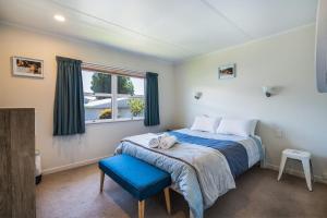 a bedroom with a bed and a blue chair at Sunny Richmond Retreat in Richmond