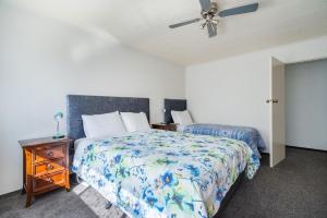 a bedroom with two beds and a ceiling fan at Stay and Play in Motueka in Motueka