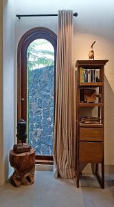 una camera con finestra ad arco con libreria e mensola di Casa Benna - Salatiga a Salatiga