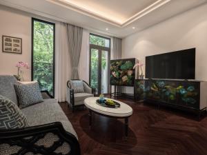 a living room with a couch and a flat screen tv at Elegant Mansion 88 in Hanoi