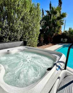 a jacuzzi tub in a backyard next to a pool at Desert Oasis- *Pool and Hot Tub* in Phoenix