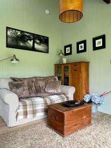 a living room with a couch and a coffee table at Jindabyne - Kia Ora Cabin Farmstay in Moonbah