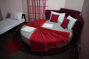 a bedroom with a bed with a red blanket on it at Airport Villa D 87 in Katunayaka