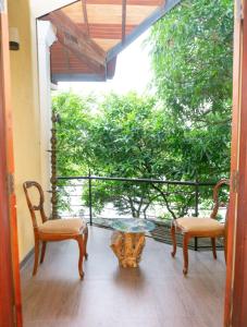 a room with two chairs and a table on a balcony at Airport Villa D 87 in Katunayake