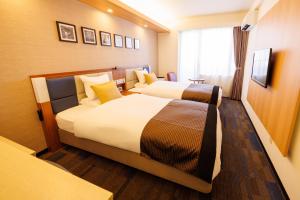 Postel nebo postele na pokoji v ubytování Floral Hotel East Shinsaibashi
