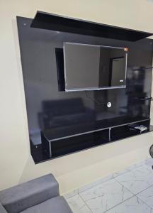 a flat screen tv hanging on a wall at Apartamento boa vista rr in Boa Vista