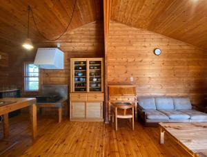 a kitchen and living room in a log cabin at Log Cottage Yamanohiroba - Vacation STAY 40692v in Shiso