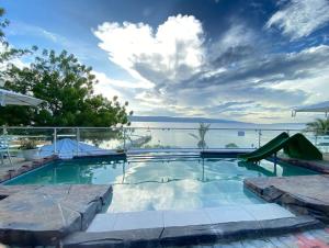 a swimming pool with a view of the water at LORELEI BEACH RESORT in Gate