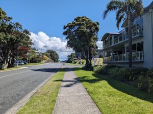 an empty street in front of a building at The Coastal Getaway in Mount Maunganui