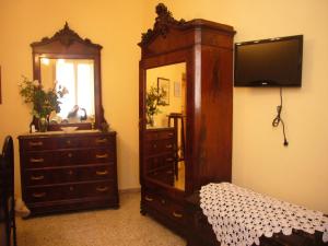 a bedroom with a dresser and a mirror and a dresser at Il Falconiere in Vicalvi