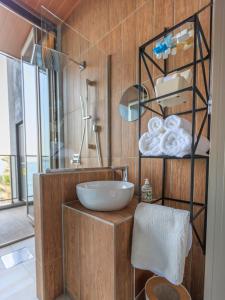 a bathroom with a sink and some towels at Alba HOTEL & Glamping in Nishinoura
