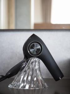 a black faucet on top of a sink at Alba HOTEL & Glamping in Nishinoura