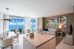 a living room with a kitchen and a living room at Zen Vacation Rentals Ocean Front at Lyfe Resort in Hollywood