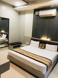 a bedroom with a large bed in a room at The highland hotel in Bathinda