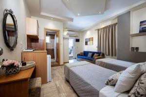 a hotel room with two beds and a living room at Panorama Studios in Mastichari
