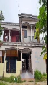 a large white house with a balcony at SPOT ON 93375 Elang Homestay in Parit