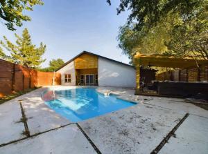 a swimming pool in the yard of a house at Ultimate Escape and Wolf Den in Lubbock