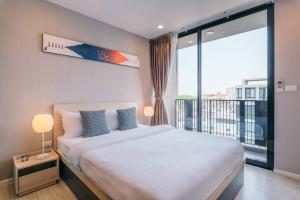 a bedroom with a large bed and a large window at Modern Condo in Nimman (F806) by Pimolplace in Chiang Mai +20 photos