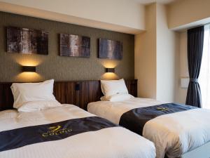 Кровать или кровати в номере Aqua Palace Chatan by Coldio Premium