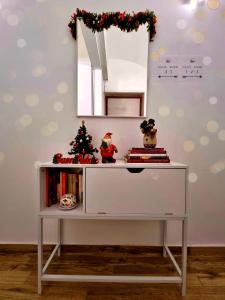a white shelf with a christmas tree and a mirror at Tiber Rooms Testaccio in Rome