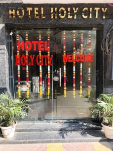 a hotel lobby with a neon sign in the window at HOTEL HOLY CITY in Amritsar