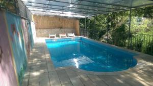 a swimming pool with two chairs next to it at Holiday House Villa Neda in Utjeha