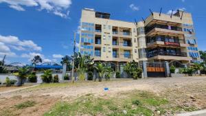 a large apartment building with a beach in front of it at SKYZ9 HOTEL in Kakamega