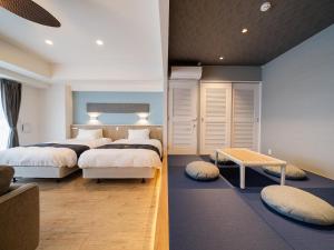 Кровать или кровати в номере Aqua Palace Chatan by Coldio Premium