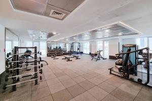 a gym with several treadmills and machines in a room at ALH VAcay - Sulafa Tower - 1 Bedroom in Dubai