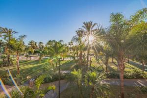 莫特里爾的住宿－Playa Granada Motril Beach and Golf，享有棕榈树公园的景色