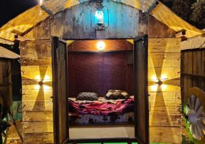 a bed in a small room in a tree house at Pawna lake Camping Lonavala in Kolvan