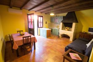 a kitchen and dining room with a table and a fireplace at Apartments Banek in Novigrad Istria