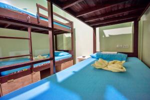 a bedroom with two bunk beds with blue sheets at Boracay Backpackers in Boracay