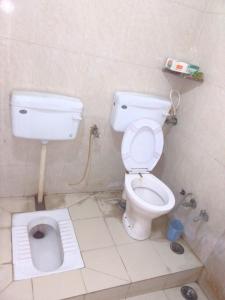a bathroom with a toilet and a sink at Shri Homes in Varanasi