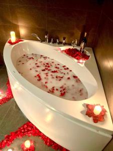 a bathroom with a white sink with candles in it at FlowerGod PentStudio Tay Ho Hanoi in Hanoi