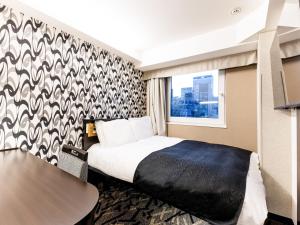a hotel room with a bed and a window at APA Hotel Kayabacho Hachobori Ekimae in Tokyo