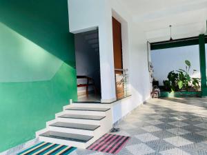 a staircase in a house with a green wall at starhive in Kalpetta