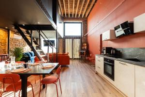 a kitchen and dining room with a table and chairs at SmartStay Bird Family - Lyon in Lyon