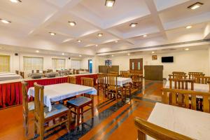 a classroom with tables and chairs in a room at Palette - Hotel Bon Sejour in Puducherry
