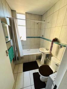 a bathroom with a toilet and a tub and a sink at Private Room Chez Khanyi Homestays in Pretoria