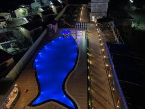 a view of a blue bowling alley at night at I Light Beach Resort in Mandarmoni