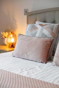 a close up of a bed with a pillow on it at Farringdon/St Pancras penthouse in London