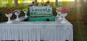 a white table with vases of flowers on it at Hotel Adhiraj Regency, Ashoknagar in Ashoknagar