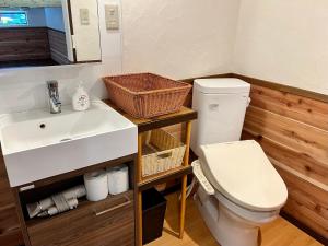 a bathroom with a toilet and a sink at カナカヴィレッジ in Ogasawara